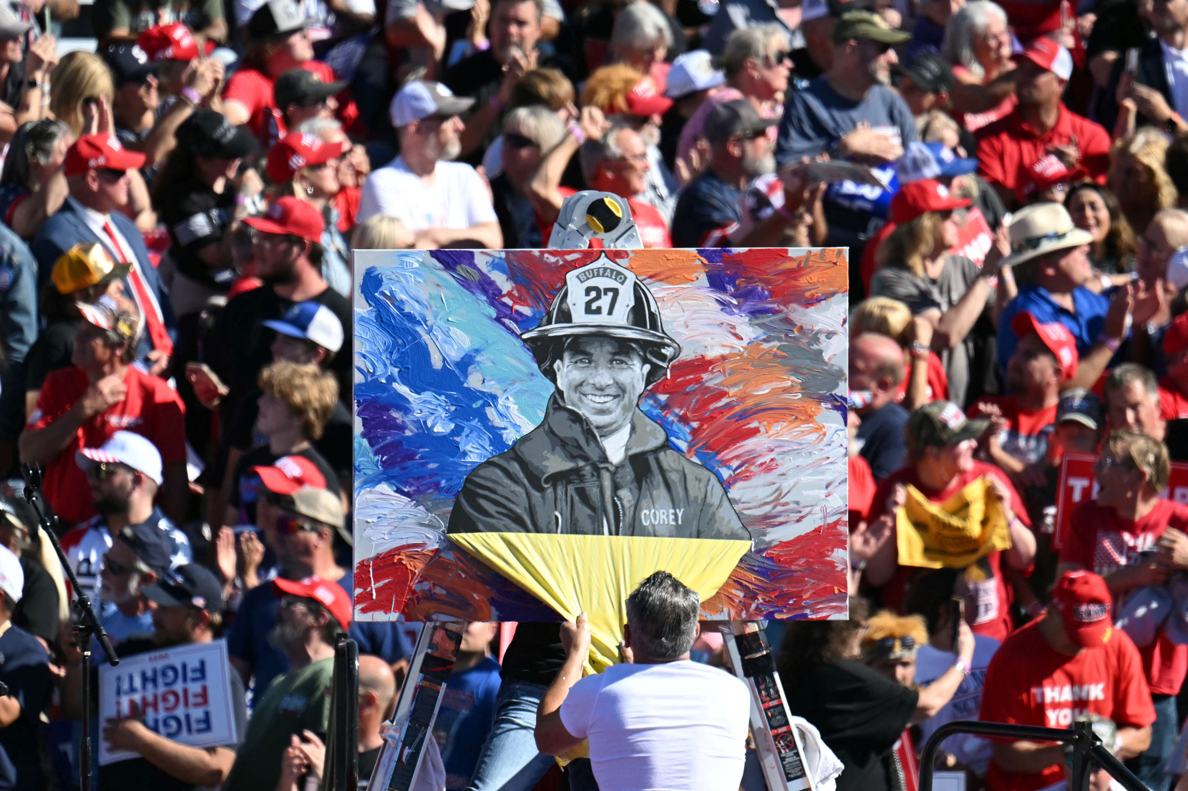 Artist Scott LoBaido unveils a portrait of firefighter Corey Comperatore ahead of Donald Trump’s return to Butler, Pennsylvania, on Oct. 5, 2024.