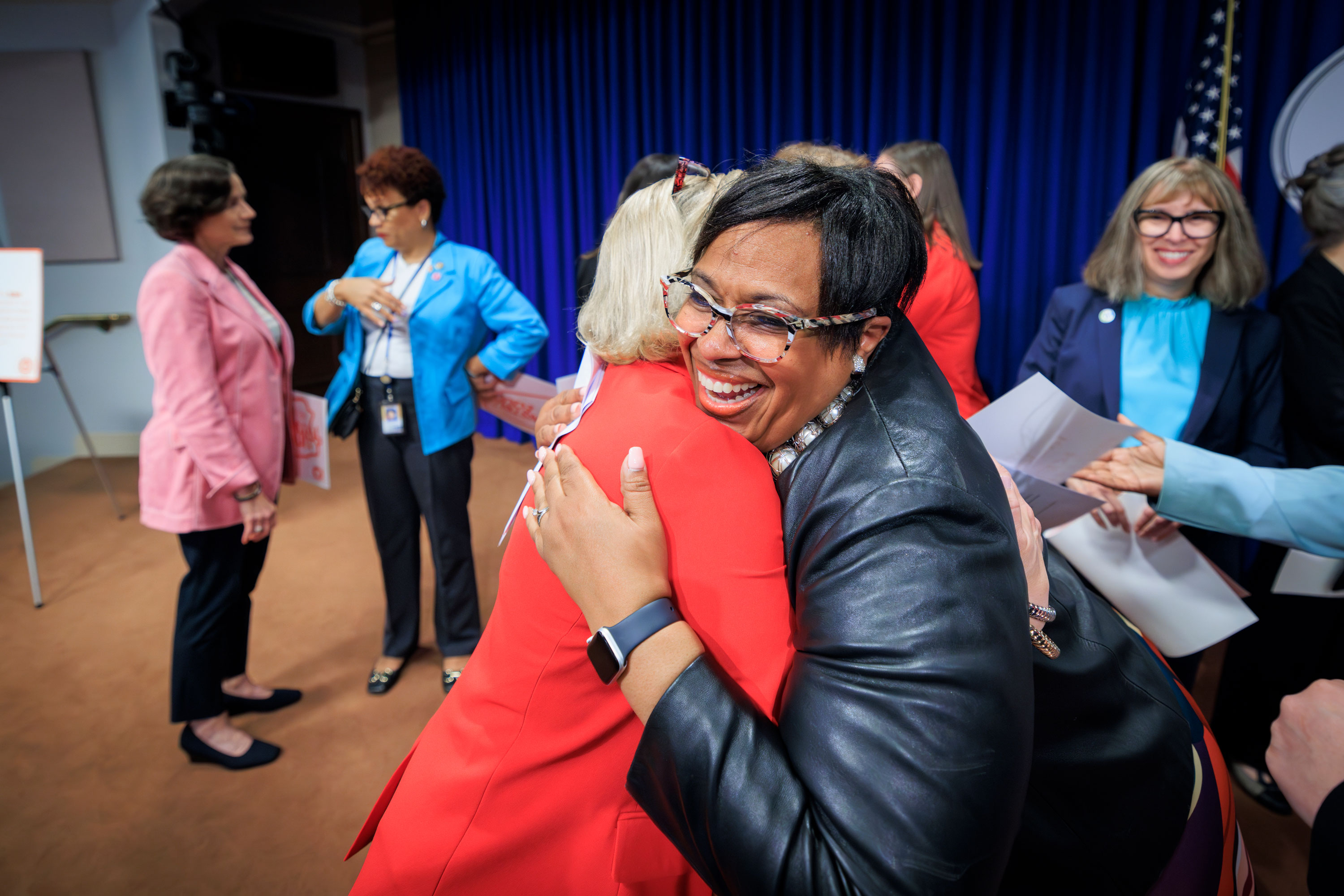 State Rep. Darisha Parker embraces a woman during an event.