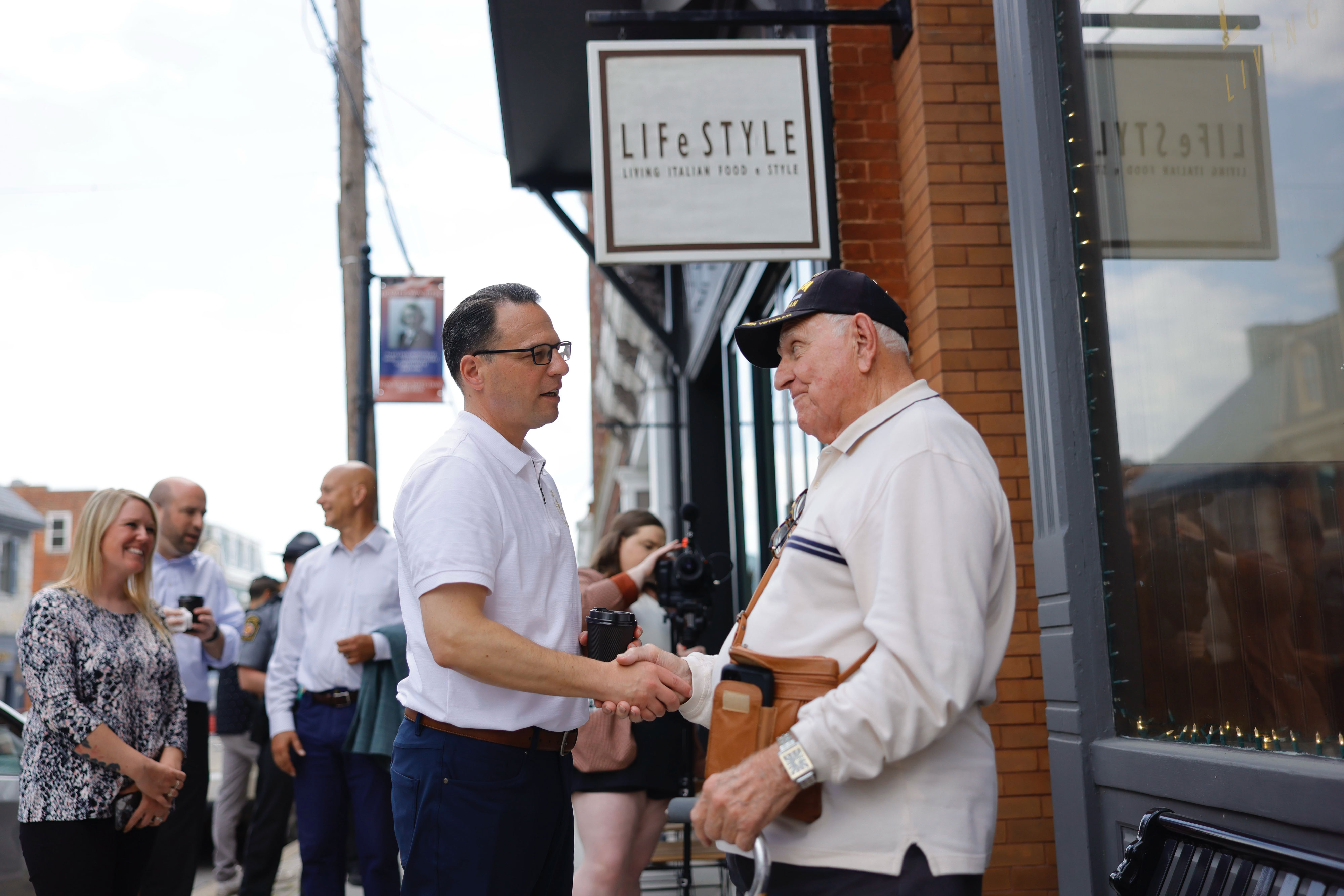 Shapiro speaks with a community member during his trip to Bedford.