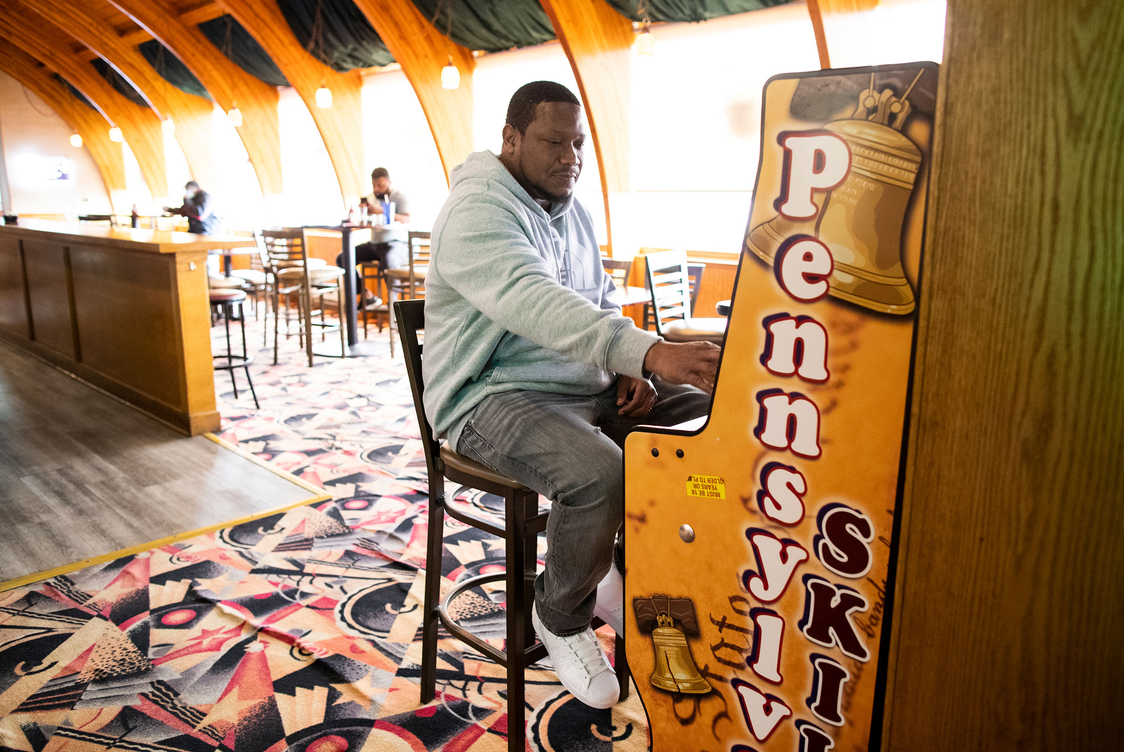                  A man plays a Pennsylvania Skill machine.