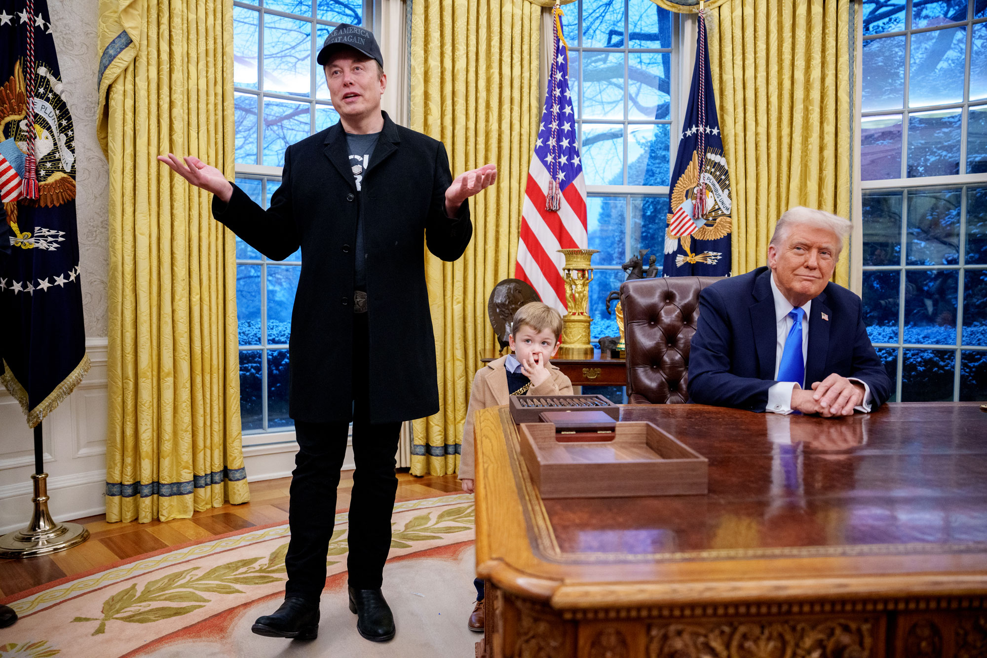 Elon Musk, his son, X Æ A-Xii, and President Donald Trump during a press conference in the Oval Office.